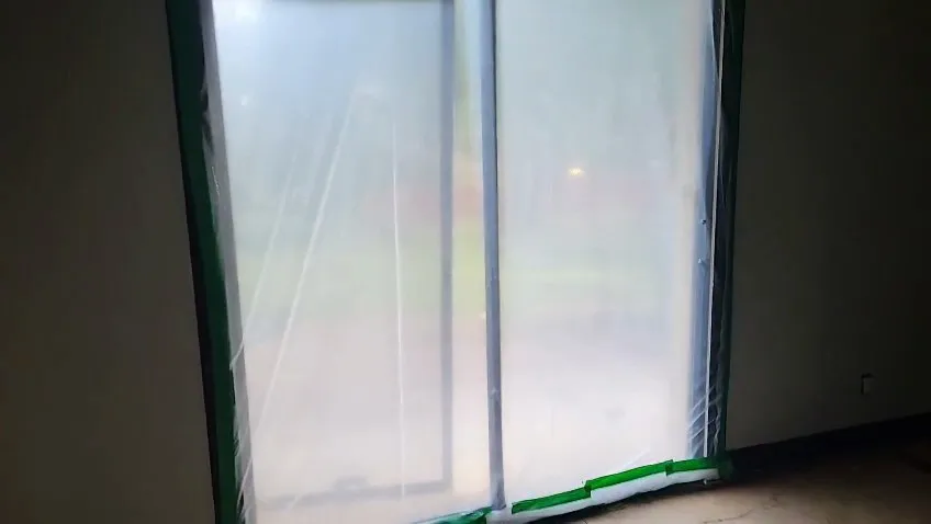 Plastic sealed over a door opening