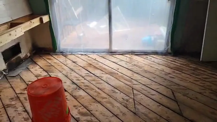 Fire-damaged room stripped down to the subfloor