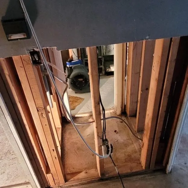 Basement bathroom with drywall removed to the studs