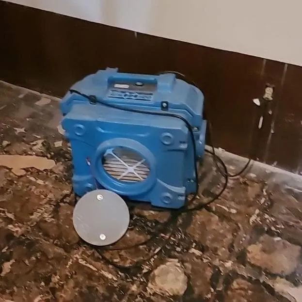 HEPA air scrubber in a contained room