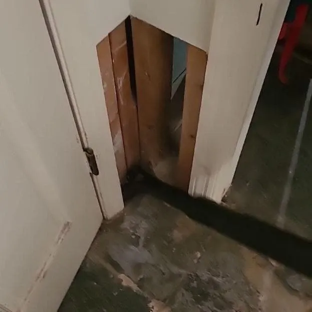 Wall base opened where materials were sampled