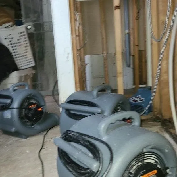 Air movers aimed at exposed wall framing