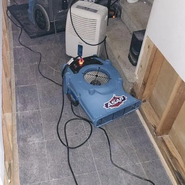 Dehumidifier and air mover drying a hallway
