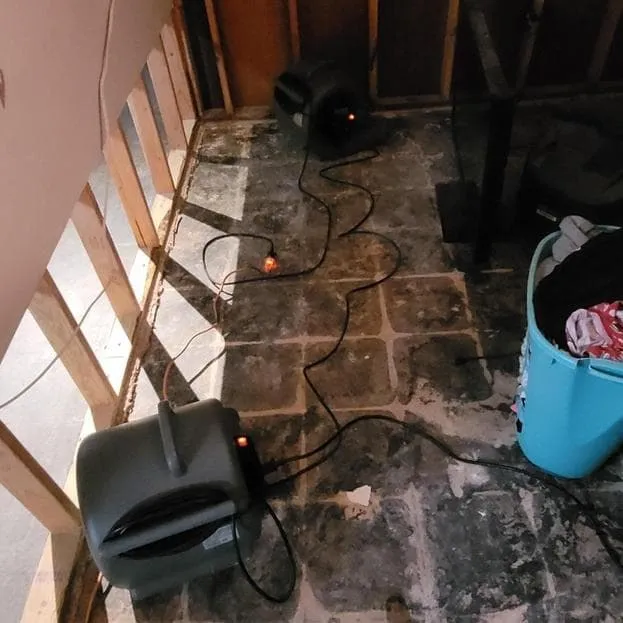 Air movers drying the floor